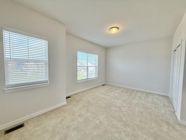 spare room with carpet flooring and baseboards