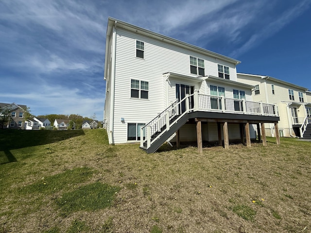 rear view of house with stairway, a deck, a yard, and a residential view