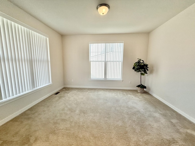 empty room with carpet and baseboards