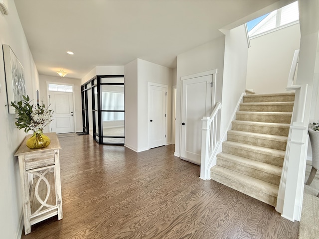 entryway featuring stairs, wood finished floors, baseboards, and recessed lighting