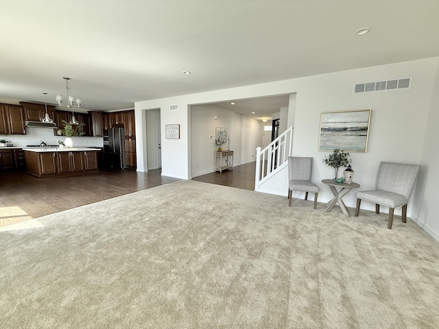living room with carpet floors, baseboards, stairway, a chandelier, and recessed lighting