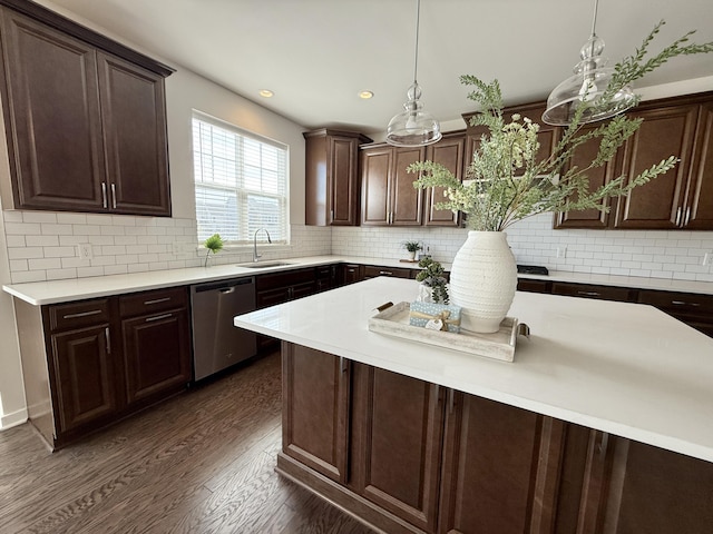 kitchen with stainless steel dishwasher, a sink, light countertops, dark brown cabinetry, and recessed lighting