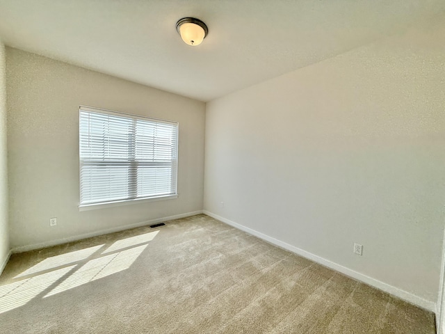 carpeted spare room with baseboards