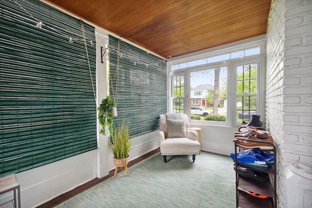 sunroom with wooden ceiling and baseboards