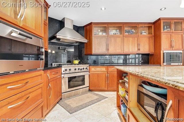 21838 Van K Dr, Grosse Pointe Woods, MI 48236 - kitchen featuring stainless steel appliances, wall chimney exhaust hood, tasteful backsplash, light tile patterned floors, and recessed lighting
