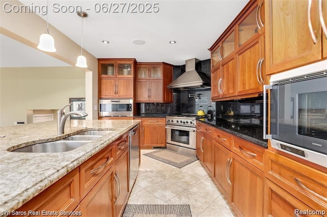 21838 Van K Dr, Grosse Pointe Woods, MI 48236 - kitchen featuring wall chimney exhaust hood, appliances with stainless steel finishes, decorative backsplash, pendant lighting, and brown cabinets