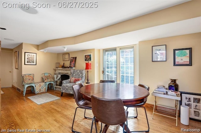 21838 Van K Dr, Grosse Pointe Woods, MI 48236 - dining space with light wood-style floors and a fireplace