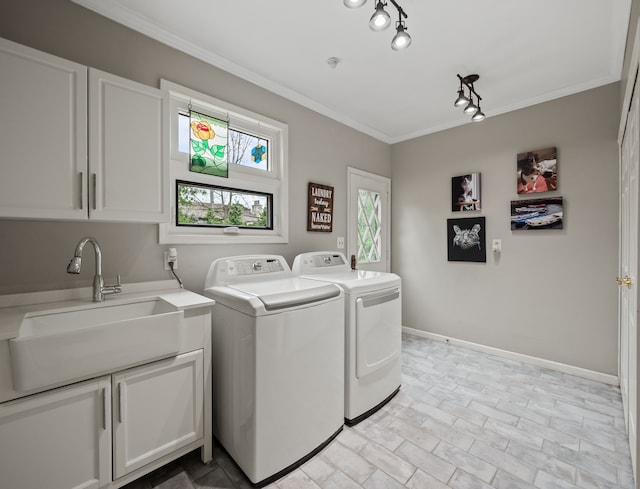 clothes washing area with separate washer and dryer, cabinet space, ornamental molding, and baseboards