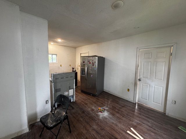 1143 Ballard St, Lansing, MI 48906 - unfurnished living room featuring dark wood-style flooring