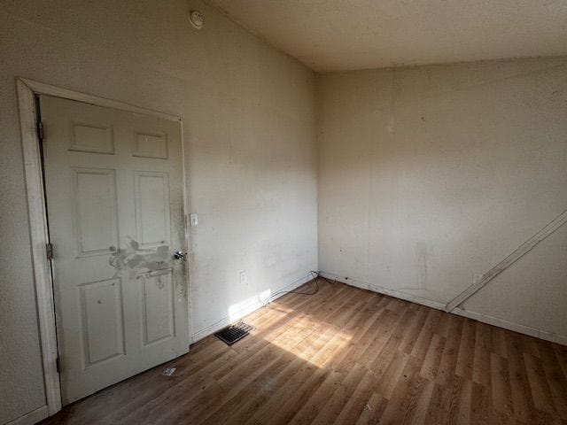 1143 Ballard St, Lansing, MI 48906 - unfurnished room with wood finished floors and baseboards