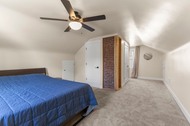 bedroom with carpet flooring, vaulted ceiling, a ceiling fan, and baseboards