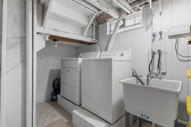 clothes washing area featuring washer and dryer
