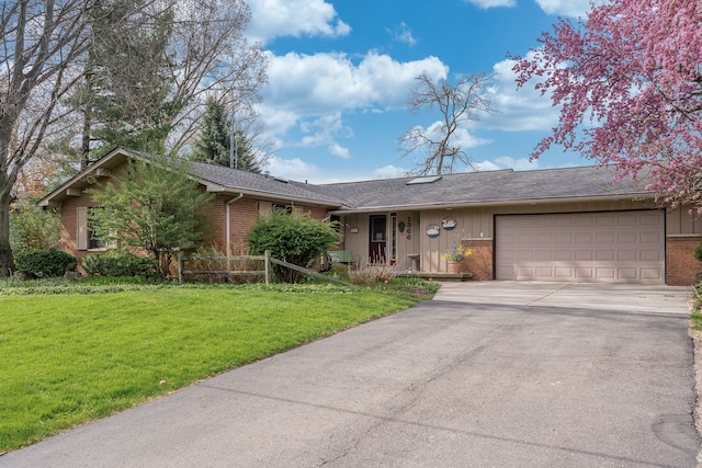 1366 E Coon Lake Rd, Howell, MI 48843 - ranch-style house with brick siding, a garage, concrete driveway, and a front lawn