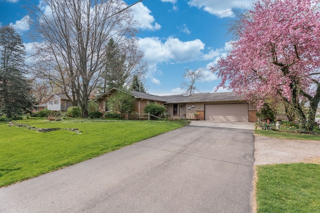 1366 E Coon Lake Rd, Howell, MI 48843 - ranch-style home with driveway, a garage, a front yard, and brick siding