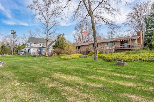 1366 E Coon Lake Rd, Howell, MI 48843 - view of green lawn with a deck