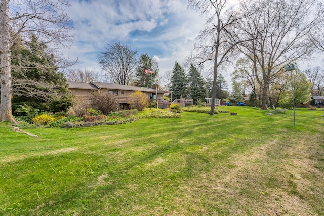 1366 E Coon Lake Rd, Howell, MI 48843 - view of green lawn featuring a deck