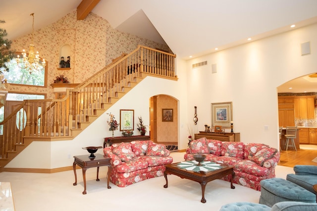 2865 Vw Ave E, Vicksburg, MI 49097 - living room with arched walkways, high vaulted ceiling, stairway, beam ceiling, and a chandelier