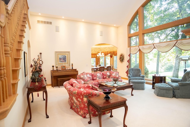 2865 Vw Ave E, Vicksburg, MI 49097 - carpeted living area with arched walkways, a chandelier, a high ceiling, and recessed lighting