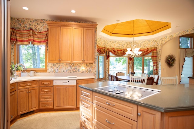 2865 Vw Ave E, Vicksburg, MI 49097 - kitchen with electric cooktop, a sink, paneled dishwasher, a chandelier, and a raised ceiling