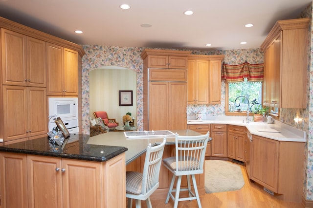 2865 Vw Ave E, Vicksburg, MI 49097 - kitchen with a center island, wallpapered walls, light wood-style flooring, recessed lighting, and a breakfast bar area