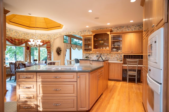 2865 Vw Ave E, Vicksburg, MI 49097 - kitchen featuring black electric stovetop, a chandelier, dark countertops, light wood finished floors, and glass insert cabinets