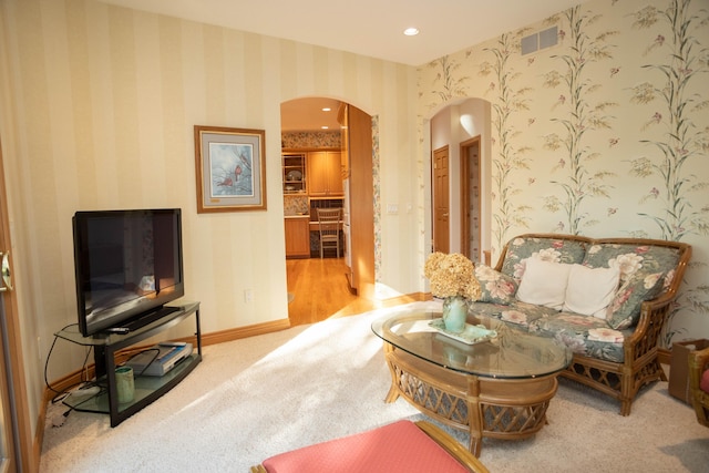 2865 Vw Ave E, Vicksburg, MI 49097 - living area with arched walkways, wallpapered walls, carpet, baseboards, and recessed lighting