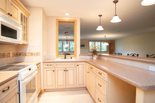 2865 Vw Ave E, Vicksburg, MI 49097 - kitchen with white appliances, a sink, hanging light fixtures, backsplash, and glass insert cabinets