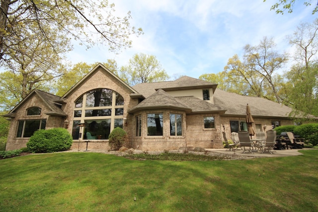 2865 Vw Ave E, Vicksburg, MI 49097 - back of house with a yard, brick siding, a patio area, and a shingled roof