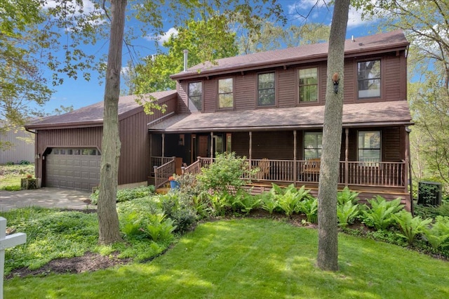view of front of home with an attached garage, a front lawn, covered porch, driveway, and a shingled roof
