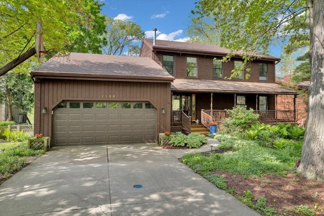 view of front of property with an attached garage, driveway, and a porch