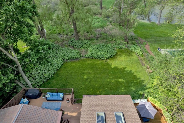 view of green lawn with a wooden deck and an outdoor living space
