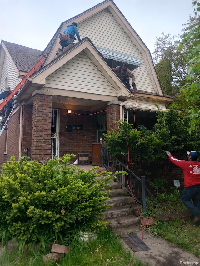 5856 Barrett St, Detroit, MI 48213 - view of front facade featuring brick siding and a porch