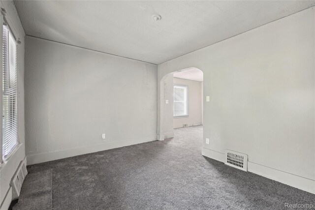 5856 Barrett St, Detroit, MI 48213 - empty room featuring arched walkways and carpet