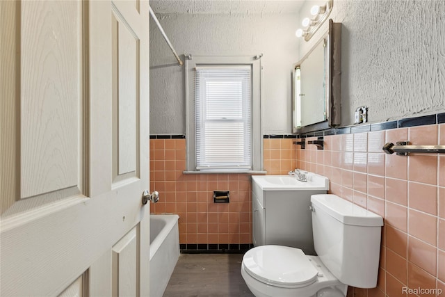 5856 Barrett St, Detroit, MI 48213 - bathroom featuring tile walls, a bathtub, wainscoting, vanity, and a shower