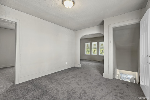 5856 Barrett St, Detroit, MI 48213 - carpeted empty room with arched walkways and baseboards
