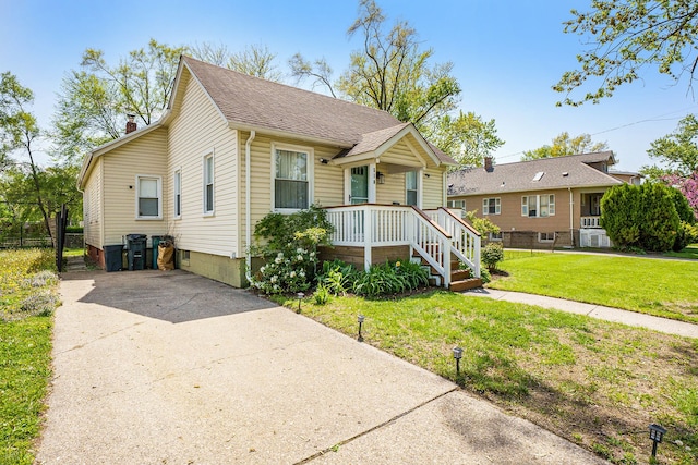 bungalow-style home with concrete driveway and a shingled roof