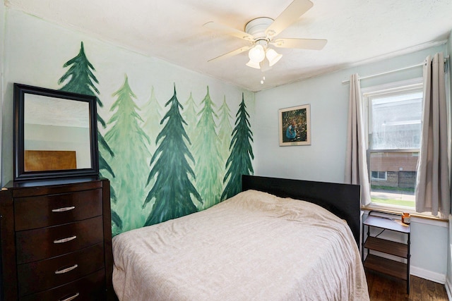 bedroom with wood finished floors, baseboards, and a ceiling fan