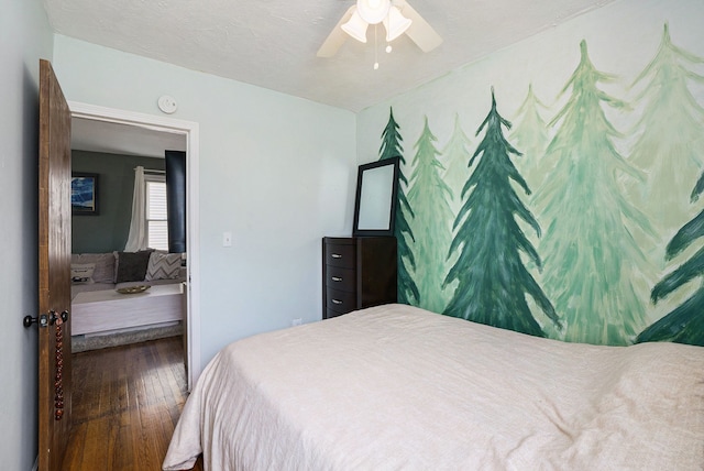 bedroom with hardwood / wood-style floors and ceiling fan
