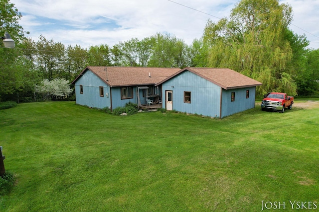 back of property with a lawn