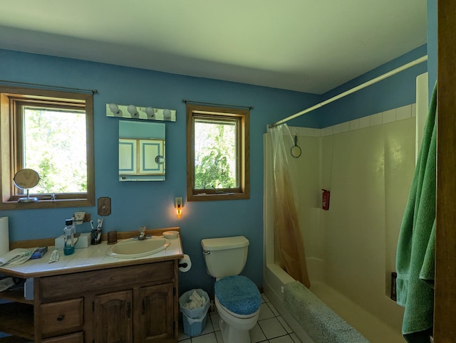 bathroom featuring toilet, healthy amount of natural light, tile patterned floors, and vanity