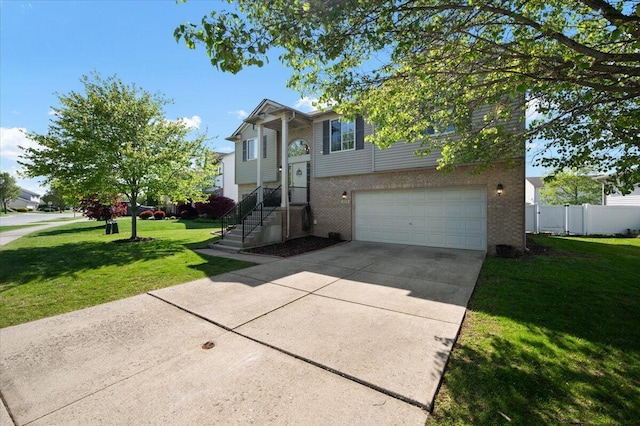215 Caribou Run, Dundee, MI 48131 - bi-level home with a garage, driveway, and brick siding