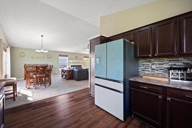 215 Caribou Run, Dundee, MI 48131 - kitchen featuring freestanding refrigerator, dark brown cabinets, a chandelier, vaulted ceiling, and backsplash