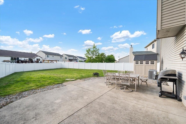 215 Caribou Run, Dundee, MI 48131 - view of patio / terrace featuring outdoor dining area, central AC, a shed, an outdoor structure, and a grill