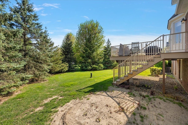 view of grassy yard featuring stairway
