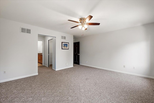 unfurnished room with a ceiling fan, baseboards, and carpet