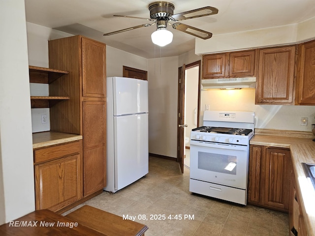 1551 Division St, Saginaw, MI 48602 - kitchen with white appliances, under cabinet range hood, brown cabinets, ceiling fan, and open shelves