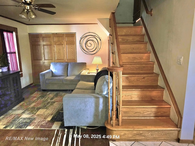 1551 Division St, Saginaw, MI 48602 - living area featuring a ceiling fan, stairway, and baseboards