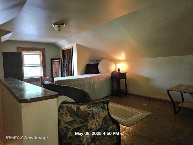 1551 Division St, Saginaw, MI 48602 - bedroom with lofted ceiling, baseboards, and wood finished floors