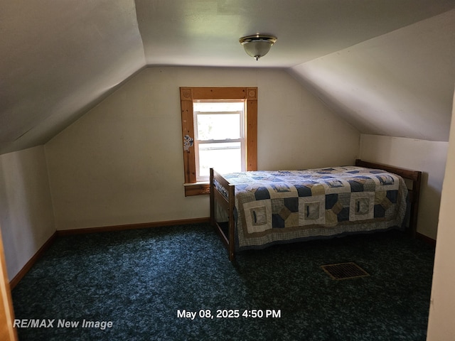 1551 Division St, Saginaw, MI 48602 - bedroom featuring lofted ceiling, carpet floors, and baseboards