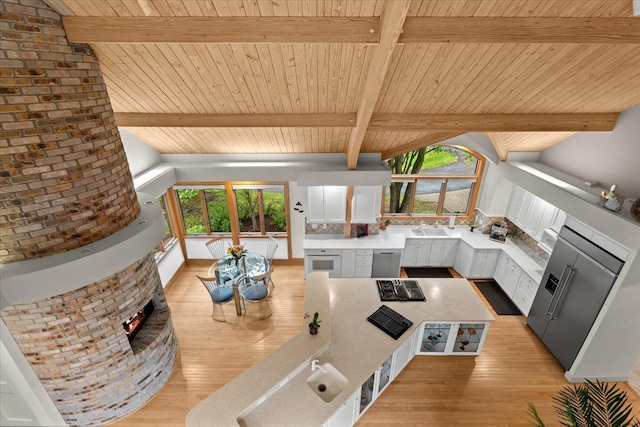 5226 Pleasant Hill Dr, Fenton, MI 48430 - dining room with light wood finished floors, wood ceiling, and a fireplace